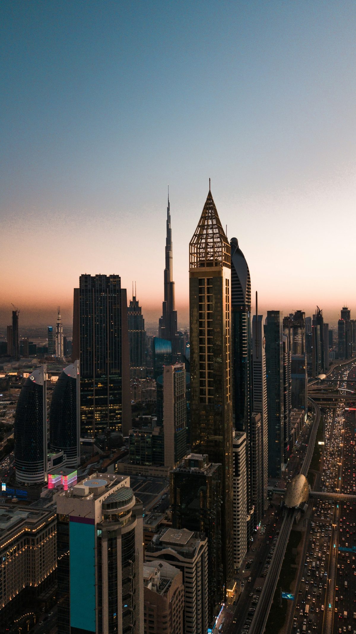Sheikh Zayed Road towers and the Dubai Metro line at dusk