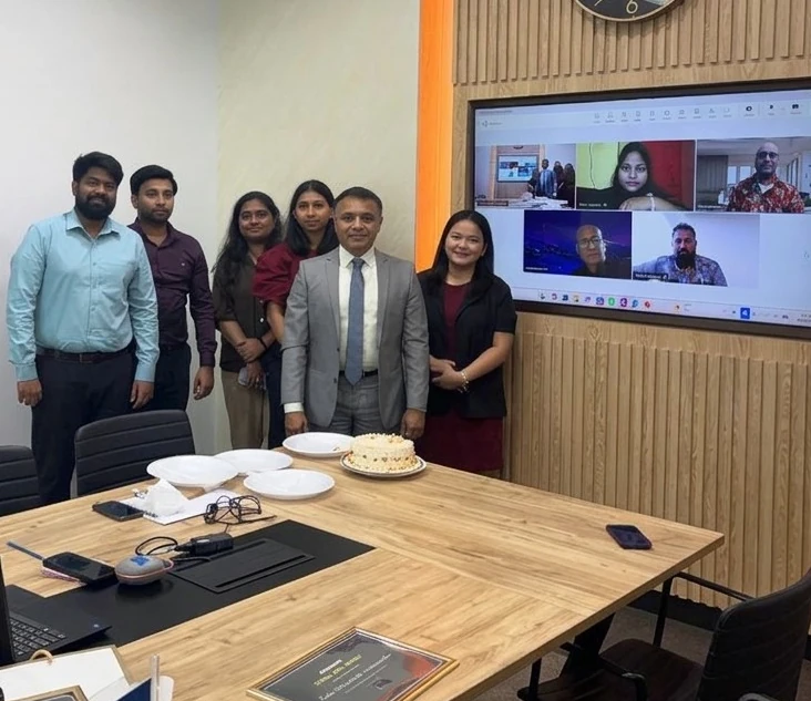 The Adventant team in the Dubai office with colleagues joining on screen